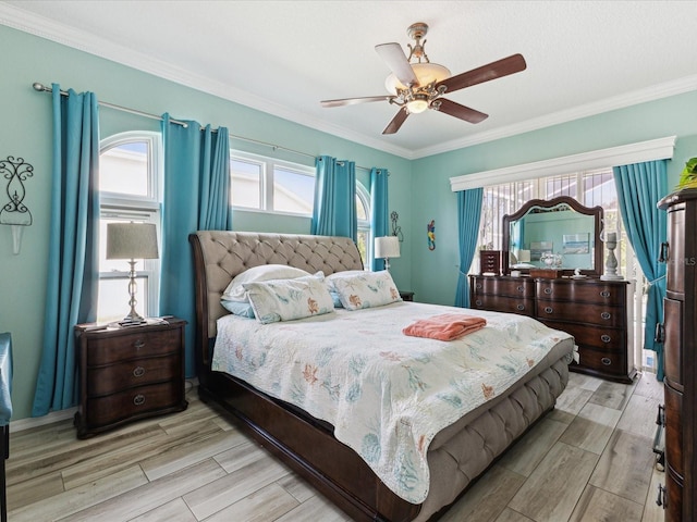 bedroom featuring light wood-style floors, multiple windows, and ornamental molding