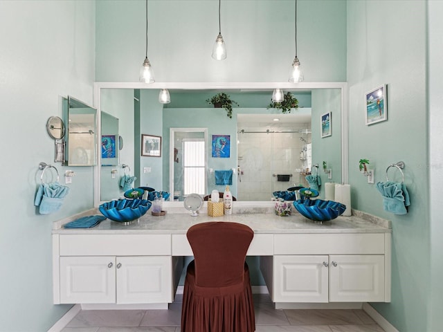 bathroom with a high ceiling, a shower stall, and vanity