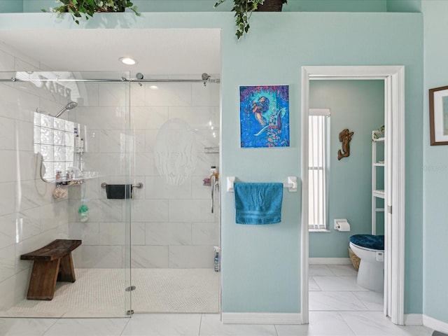 bathroom with baseboards, a shower stall, toilet, and marble finish floor