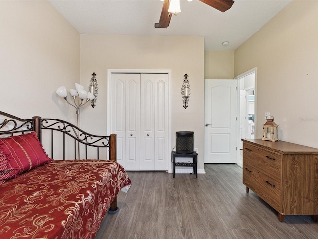 bedroom featuring a closet, ceiling fan, and dark wood-type flooring