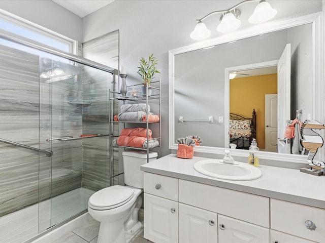 bathroom with vanity, connected bathroom, a stall shower, and toilet