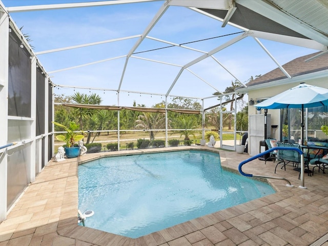 outdoor pool with a patio and glass enclosure
