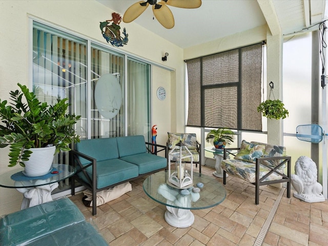 sunroom / solarium with ceiling fan, outdoor lounge area, and plenty of natural light