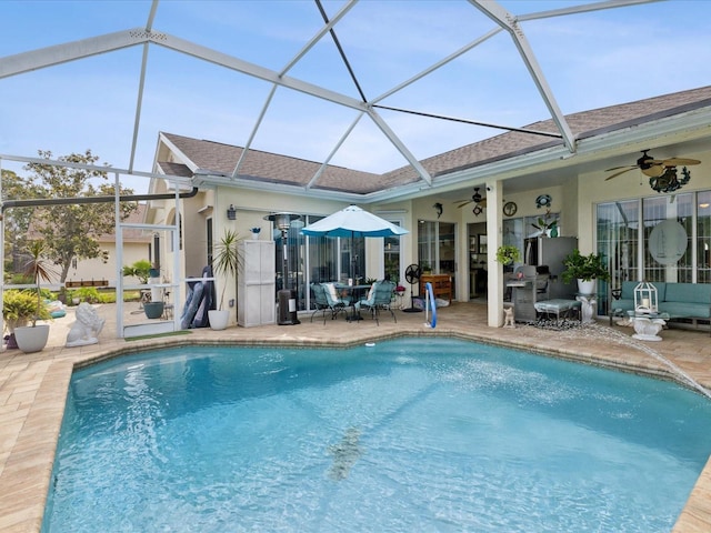 pool featuring a lanai, a patio, and a ceiling fan