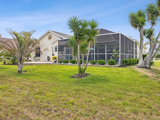 view of front of home featuring a lanai, a front lawn, and stucco siding