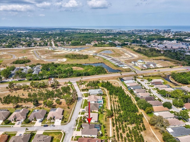 birds eye view of property featuring a water view and a residential view