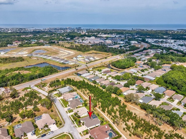 bird's eye view with a residential view and a water view