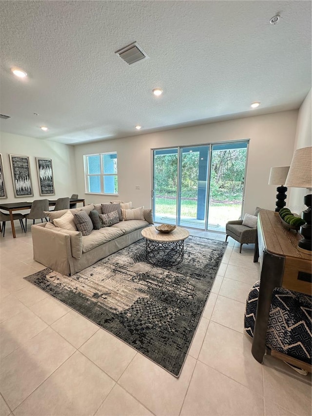 5236 Luisa Ct, Saint Cloud, FL 34771 - living room with plenty of natural light, light tile patterned flooring, a textured ceiling, and recessed lighting
