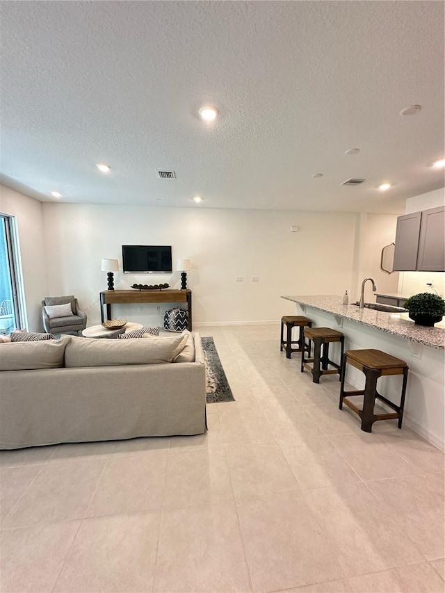 5236 Luisa Ct, Saint Cloud, FL 34771 - living area featuring a textured ceiling, recessed lighting, light tile patterned floors, and baseboards