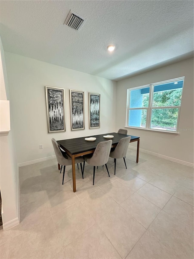 5236 Luisa Ct, Saint Cloud, FL 34771 - dining area featuring a textured ceiling, baseboards, and light tile patterned floors