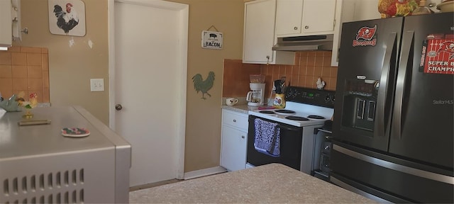 kitchen featuring tasteful backsplash, white cabinets, electric stove, black fridge, and under cabinet range hood