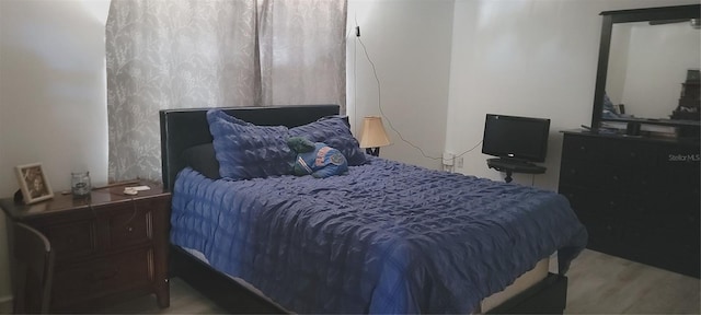 bedroom with wood finished floors