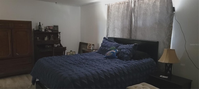 bedroom with wood finished floors