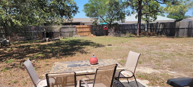 view of yard featuring a fenced backyard, a patio area, and outdoor dining space
