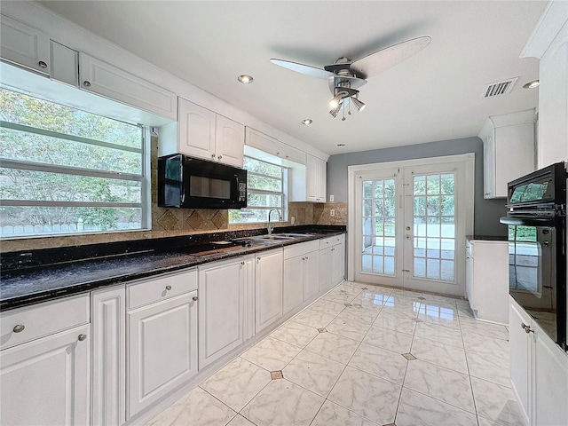 5147 Larch Ln, New Port Richey, FL 34653 - kitchen featuring ceiling fan, visible vents, plenty of natural light, and black appliances