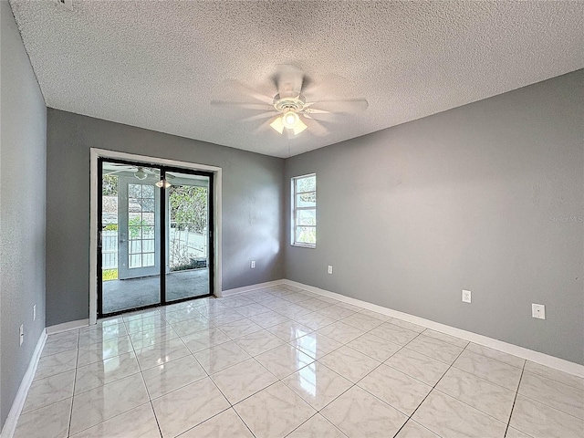 5147 Larch Ln, New Port Richey, FL 34653 - spare room featuring baseboards, a ceiling fan, and a textured ceiling