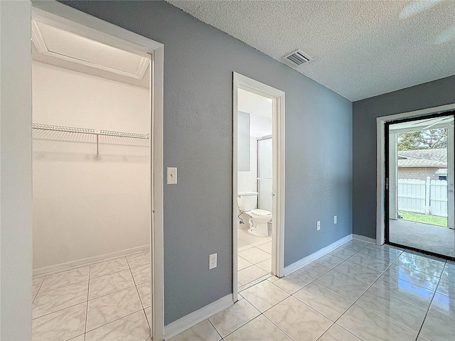5147 Larch Ln, New Port Richey, FL 34653 - unfurnished bedroom featuring a textured ceiling, access to exterior, visible vents, baseboards, and marble finish floor