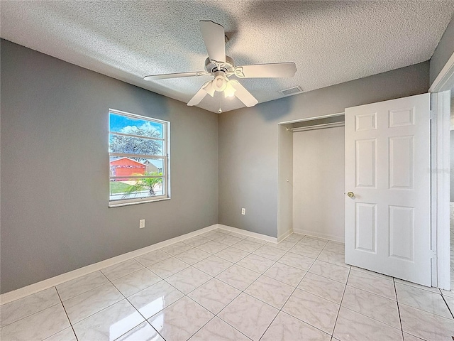 5147 Larch Ln, New Port Richey, FL 34653 - unfurnished bedroom with a textured ceiling, visible vents, light tile patterned floors, and a closet