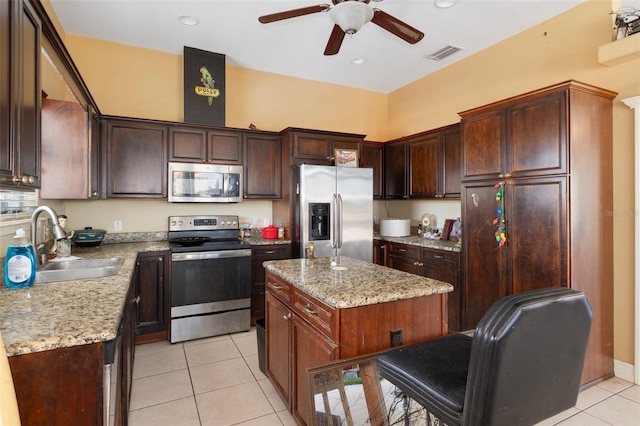 13810 Celida Ave, Hudson, FL 34667 - kitchen with appliances with stainless steel finishes, ceiling fan, a sink, visible vents, and light tile patterned flooring