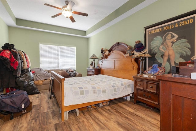 13810 Celida Ave, Hudson, FL 34667 - bedroom with wood finished floors, ceiling fan, and a tray ceiling