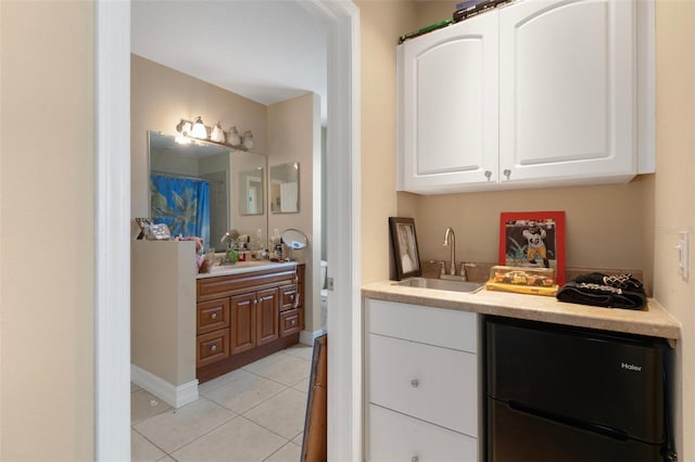 13810 Celida Ave, Hudson, FL 34667 - bar with a sink, light tile patterned flooring, wet bar, baseboards, and refrigerator