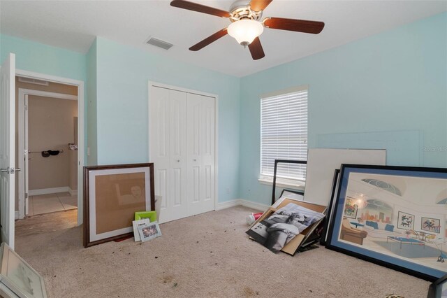 13810 Celida Ave, Hudson, FL 34667 - carpeted bedroom with baseboards, visible vents, a ceiling fan, and a closet