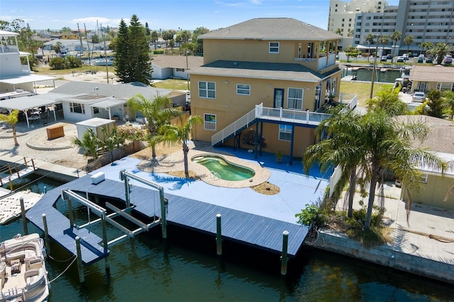 13810 Celida Ave, Hudson, FL 34667 - back of property with stairway, a balcony, a water view, an outdoor pool, and boat lift