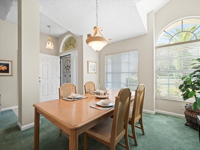 carpeted dining room with baseboards, a textured ceiling, and lofted ceiling