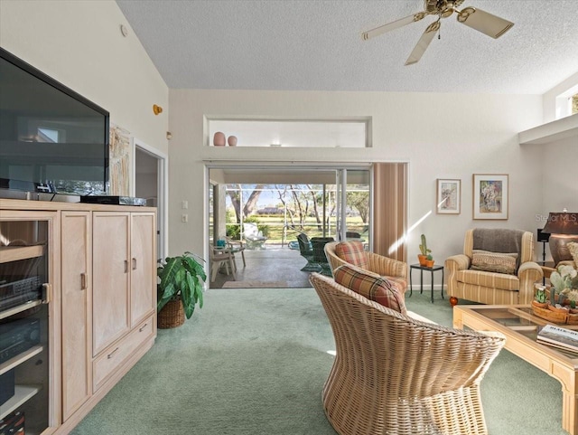 carpeted living room featuring a textured ceiling and ceiling fan