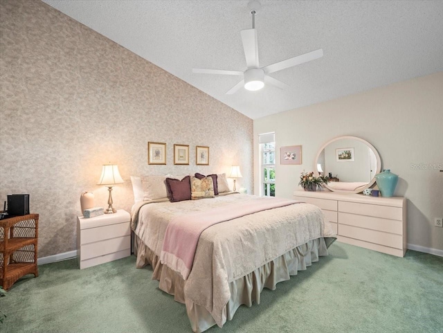 bedroom with baseboards, wallpapered walls, lofted ceiling, and carpet flooring