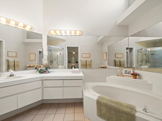 full bath featuring a garden tub, tile patterned flooring, a shower stall, and vanity