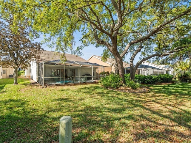 view of yard with a lanai and an outdoor pool