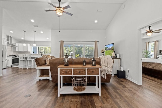 living room with a ceiling fan, baseboards, recessed lighting, and dark wood-style floors