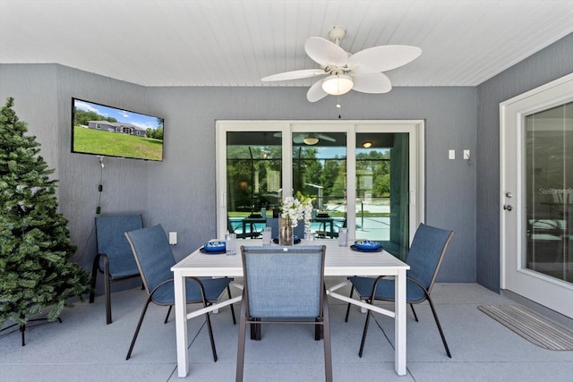 view of patio with outdoor dining space and ceiling fan