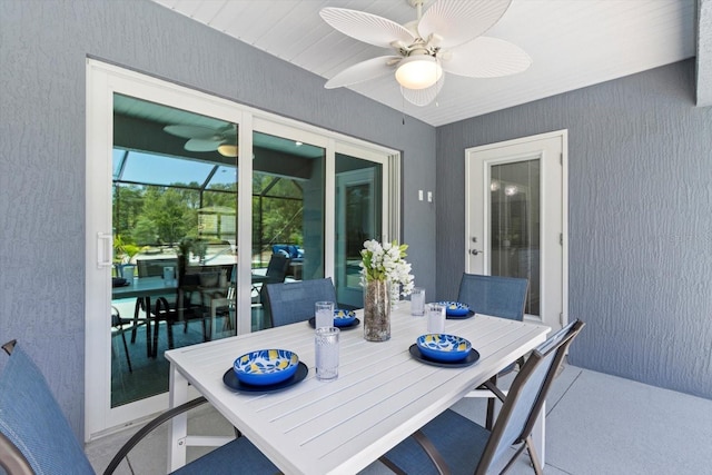 dining area with a sunroom and a ceiling fan