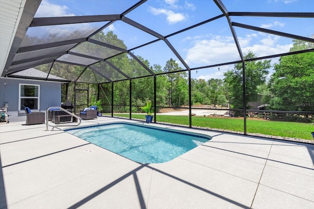 outdoor pool featuring a lawn and a patio
