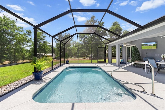 pool with ceiling fan, a yard, and a patio area