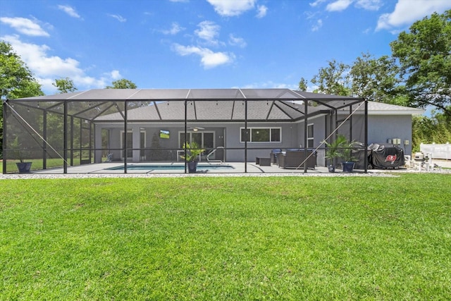 back of house featuring a lawn, a patio, glass enclosure, and an outdoor pool