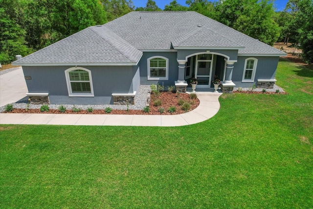 single story home with a front lawn, roof with shingles, and stucco siding