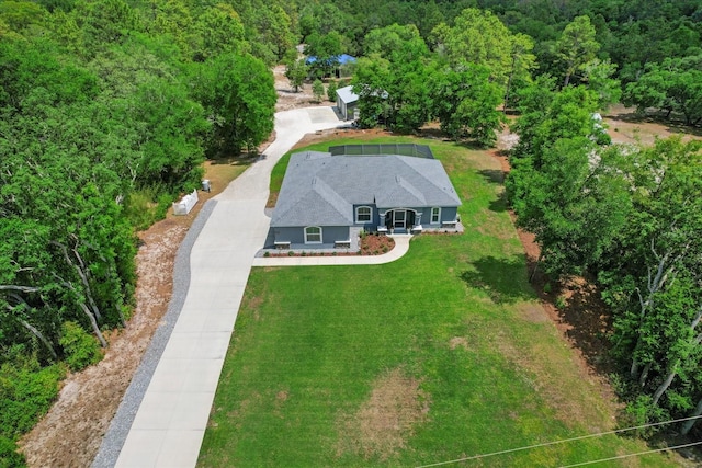 birds eye view of property with a view of trees