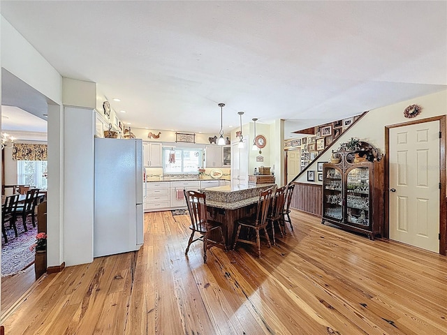 75 N Canal Dr, Palm Harbor, FL 34684 - dining area featuring light wood finished floors and stairway