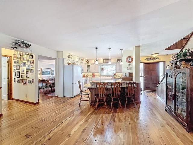 75 N Canal Dr, Palm Harbor, FL 34684 - dining room featuring baseboards and light wood finished floors
