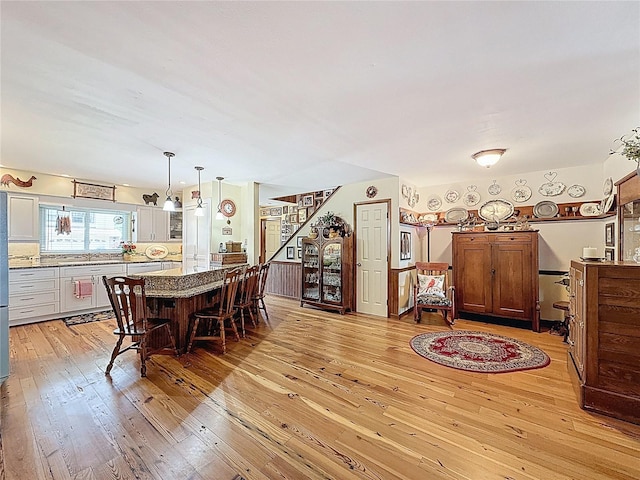75 N Canal Dr, Palm Harbor, FL 34684 - dining space with light wood-style floors and stairs
