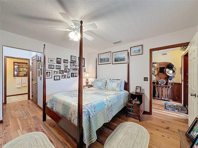 75 N Canal Dr, Palm Harbor, FL 34684 - bedroom with a textured ceiling, visible vents, and light wood-type flooring