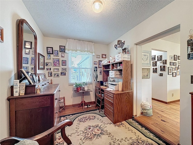 75 N Canal Dr, Palm Harbor, FL 34684 - home office with baseboards, a textured ceiling, and light wood-style flooring