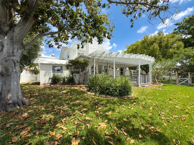 75 N Canal Dr, Palm Harbor, FL 34684 - rear view of house featuring fence, a pergola, and a yard