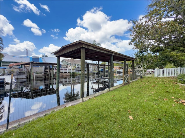 75 N Canal Dr, Palm Harbor, FL 34684 - dock area with a lawn, fence, boat lift, and a water view