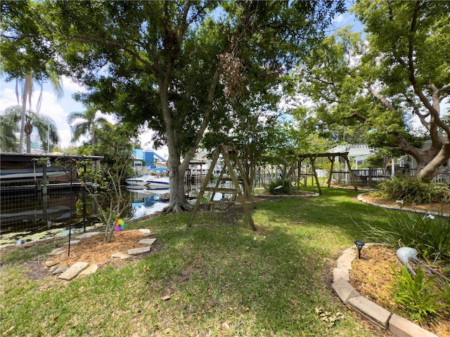75 N Canal Dr, Palm Harbor, FL 34684 - view of yard with a playground and fence