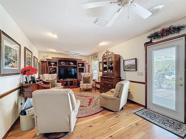 75 N Canal Dr, Palm Harbor, FL 34684 - living area featuring a ceiling fan, baseboards, visible vents, and light wood-style floors