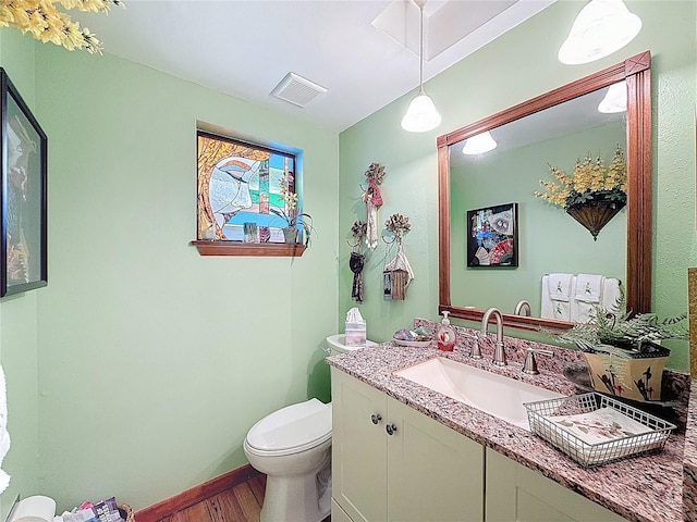 75 N Canal Dr, Palm Harbor, FL 34684 - bathroom with vanity, toilet, baseboards, wood finished floors, and visible vents